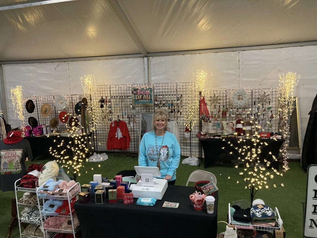 A woman standing in front of some lights